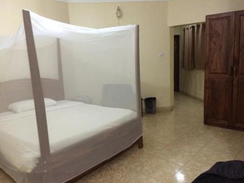 a bedroom with a white bed with a canopy at Mt Moroto Hotel in Moroto