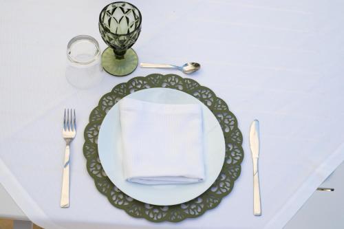 a white table with a plate with a napkin on it at Dimora TerraNostra&Spa in Ugento