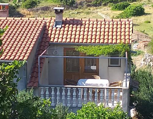 a view of a house with a balcony at Apartman Mihaela in Komiža