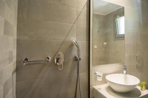 a bathroom with a shower and a sink at Paradise Vezal in Laganas