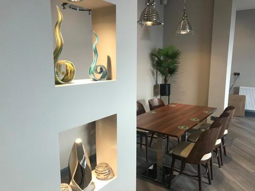 a dining room with a table and a fireplace at Pavilion Holiday Apartments in Weston-super-Mare