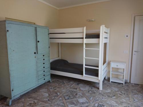 a bedroom with two bunk beds and a cabinet at Il carpino bianco in Puegnano del Garda