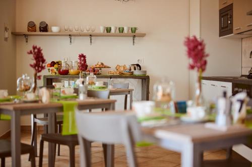 a kitchen with tables and chairs in a room at La Lanterna del Borgo in San Donato