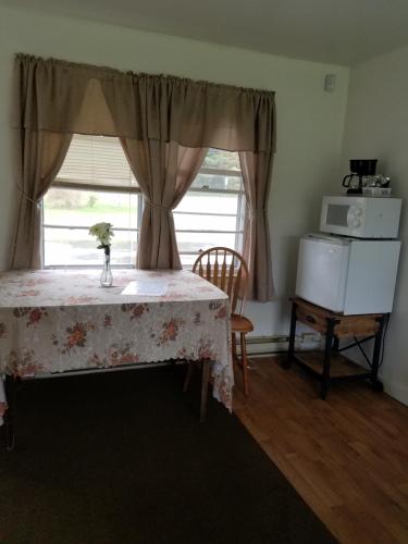 a bedroom with a table and a window at The becket Motel in Becket Center
