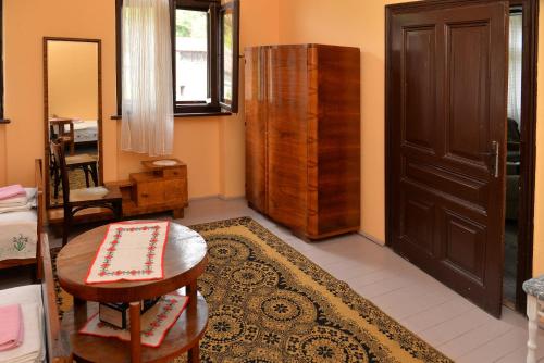 a room with a door and a table and a rug at Country house Dunjin Konak in Rogljevo