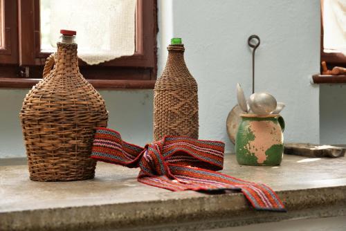 three bottles sitting on a window sill with a bow at Country house Dunjin Konak in Rogljevo
