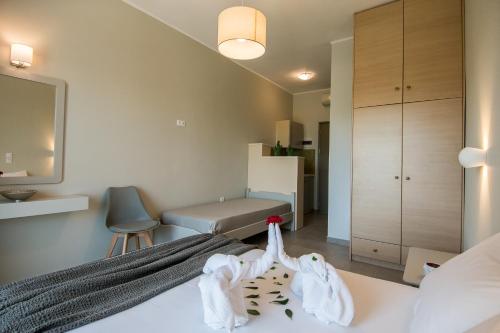 a bedroom with a bed with towels on it at Paradise Vezal in Laganas
