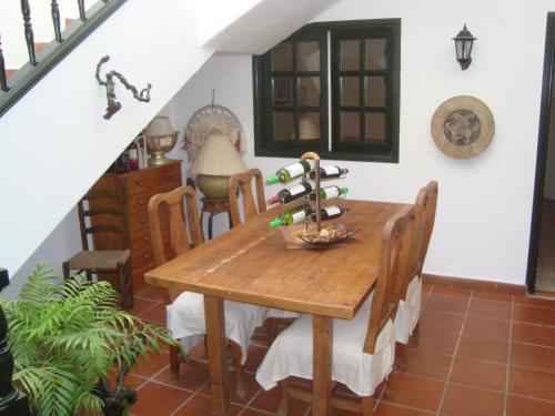a dining room table with a bunch of wine bottles on it at Home From Home in Teguise