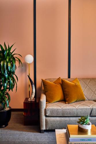 a living room with a couch and some plants at Fairlane Hotel Nashville in Nashville