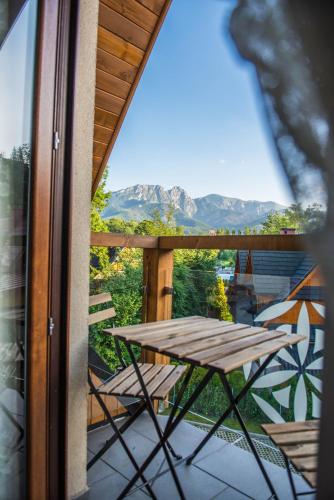 a table on a balcony with a view of a mountain at Apartamenty Gubałówka in Zakopane