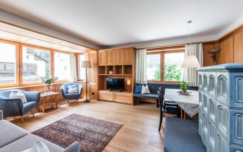 a living room with a couch and a table and chairs at B&B Villa Angelino in Ortisei