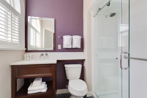 a bathroom with a toilet and a sink and a shower at Prince Conti Hotel in New Orleans