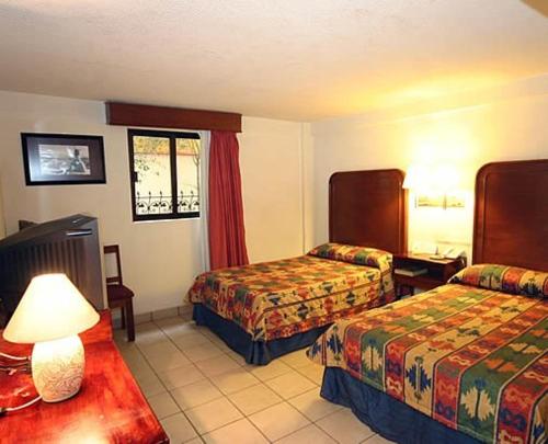 Tempat tidur dalam kamar di Hotel Calenda