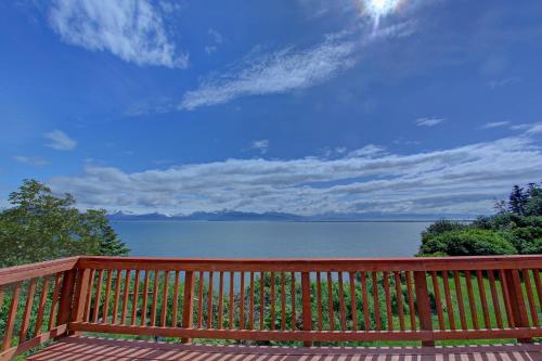 a wooden bench with a view of the water at The Lighthouse in Homer