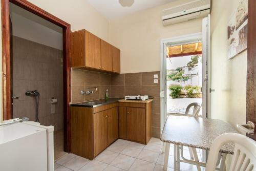 a kitchen with a sink and a table in a room at Litochoro Rooms in Plaka Litochorou