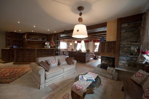 a living room with a couch and a fireplace at Relais du Berger in Aosta