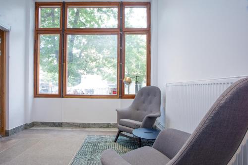 a living room with two chairs and a window at ApartDirect Sundbyberg in Sundbyberg