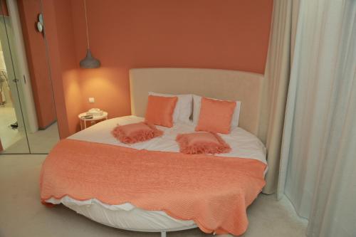 a bedroom with a bed with two pillows on it at H49 Apartman Wellness & Spa - Adults only in Sovata