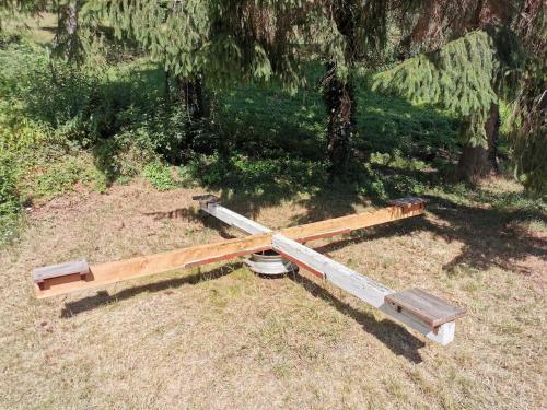 a piece of wood laying on the ground in the grass at Ferienhof Ehlers in Hülsede