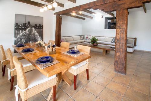 a dining room with a wooden table and chairs at Finca Arbequina in Pájara