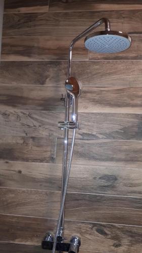 a shower head in a room with a wooden wall at Best4You Apartment - sea view - 70 m2 - 2 bedrooms in Dubrovnik