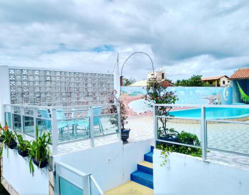 a view of the pool from the balcony of a resort at Pousada Azul in Canoa Quebrada