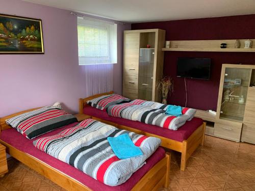 a bedroom with two beds with towels on them at Pension Milada in Klecany