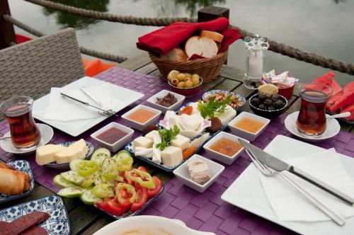 a table with cheese and other foods on it at Agva Nehir Evi - Adult Only in Ağva