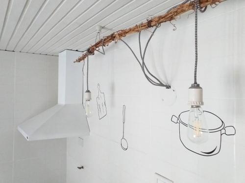 a kitchen with several lights hanging from the ceiling at CASA BONITA in Ciudad Lujan de Cuyo