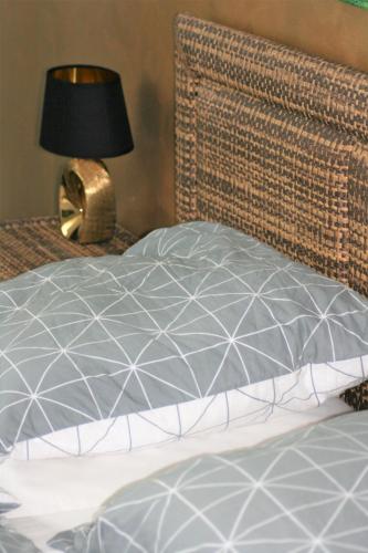 a bed with a pillow and a lamp on a table at Design Residence -Garden & Comfort in Bratislava