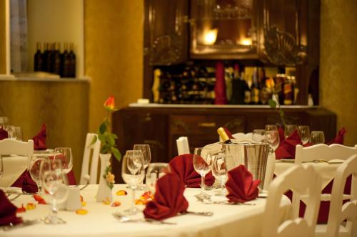 a table with red napkins and wine glasses on it at Boutique Hotel Anagennisis in Pyrgos