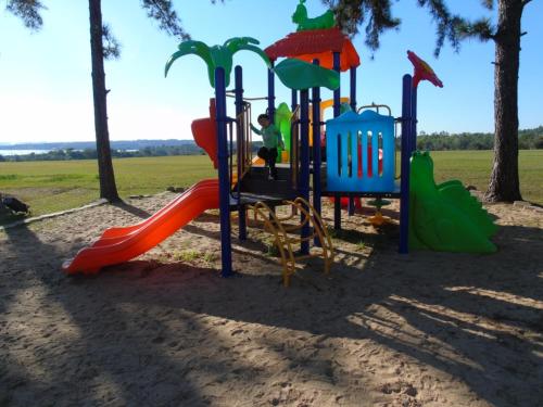 a playground at a park with a slide at Awa Resort Hotel in Encarnación