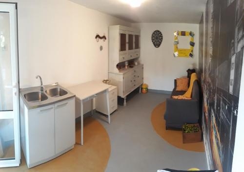 a small kitchen with a sink and a desk at Holiday Home Dioniza in Vodnjan