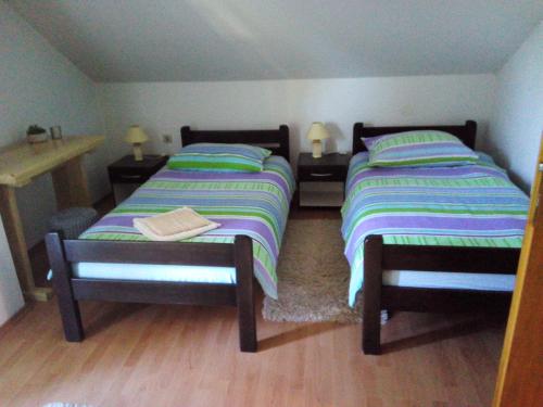 two beds sitting next to each other in a room at Nika in Ogulin