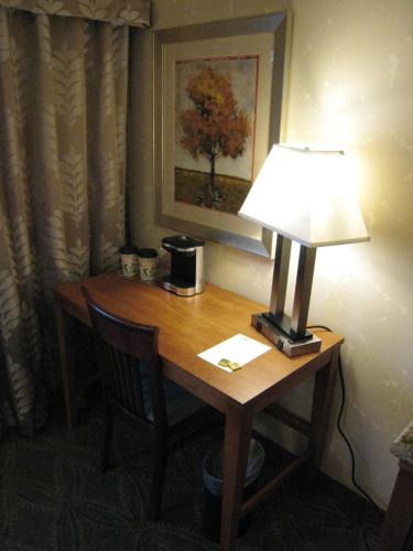 a desk with a lamp on top of a table at Wingate by Wyndham Elkins in Elkins