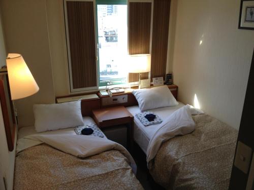 Posteľ alebo postele v izbe v ubytovaní Ace Inn Matsusaka