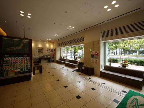 a lobby of a store with couches and a window at Hotel Route-Inn Osaka Honmachi in Osaka