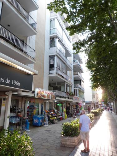 a man walking down a street in front of buildings at Lorena in Salou