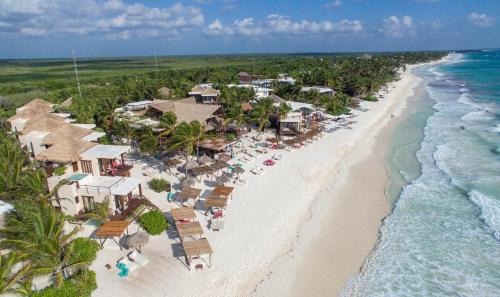 an aerial view of a beach with umbrellas and the ocean at La Zebra a Colibri Boutique Hotel in Tulum