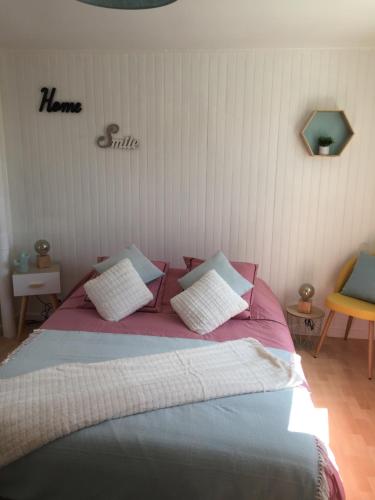 sypialnia z łóżkiem z różową pościelą i białymi poduszkami w obiekcie La Maison des Prés Disney Paris w mieście Chambry