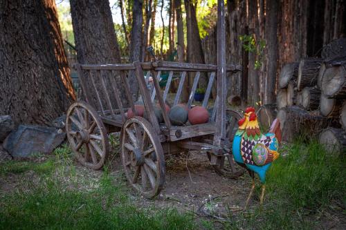 a chicken standing next to a wooden cart with balls at Dreamcatcher B&B in Taos