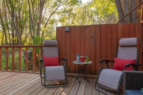 two chairs and a table on a deck at Dreamcatcher B&B in Taos