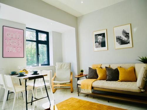 a living room with a couch and a table at Luxury 3 bedroom Apartment near Bournemouth Beach & Poole in Bournemouth