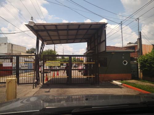 a gate to a building with a metal structure at Apartments and Rooms Distecon in Guatemala