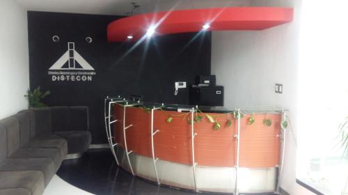 a bar in a room with a couch and a table at Apartments and Rooms Distecon in Guatemala