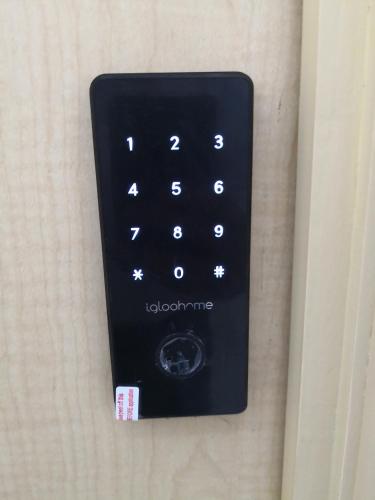 a black remote control attached to a wall at Apartments and Rooms Distecon in Guatemala