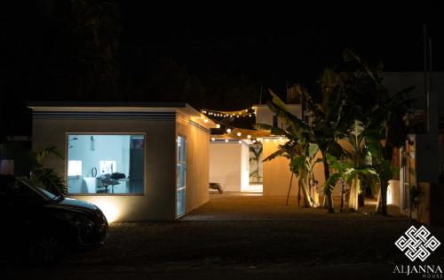 a house lit up at night with lights at Aljanna House in Bacalar