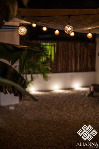 a room with lights and a table with a plant at Aljanna House in Bacalar