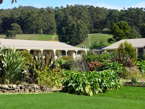 a building with a garden in the foreground at Port Arthur Villas in Port Arthur