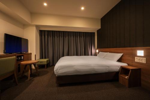 En eller flere senge i et værelse på Dormy Inn Morioka